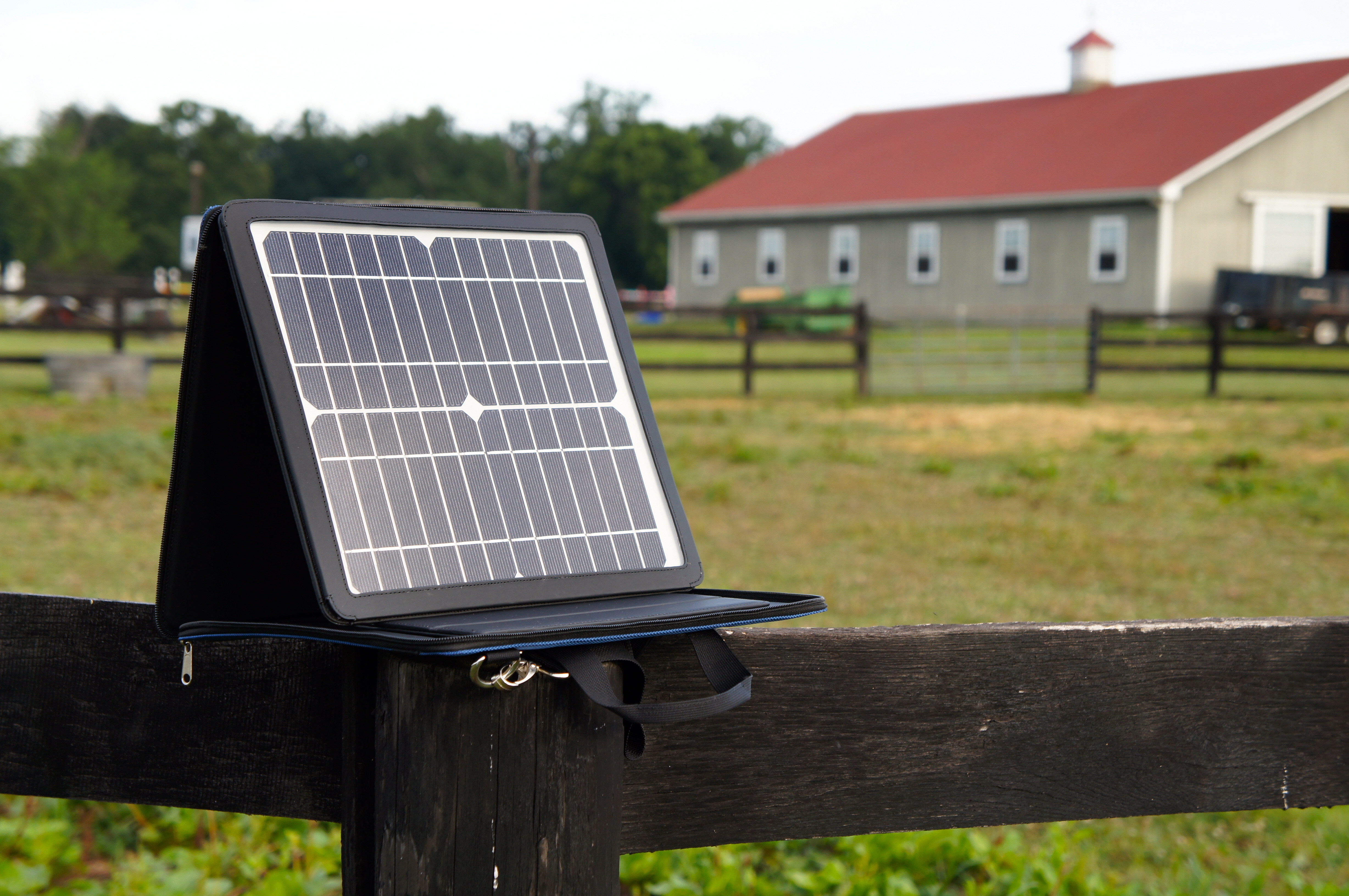 SunVolt portable solar charger on a fence post outdoors